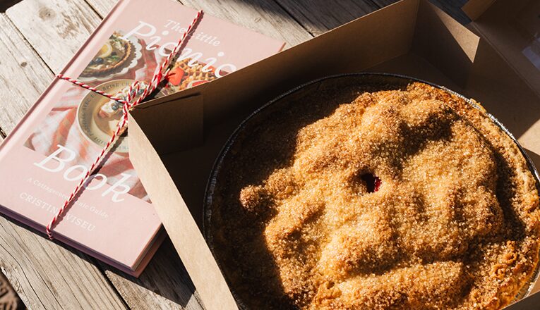 A pie sits next to a Picnic Book outside of The Whistle Stop in Union Pier, Michigan