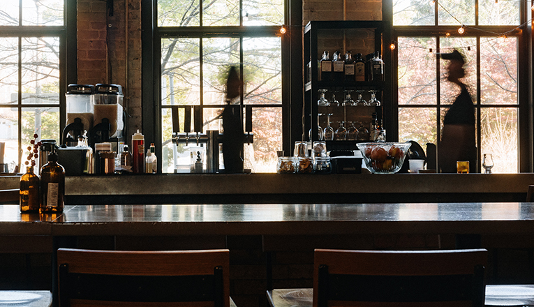 A motion blurred shot of bartenders behind the bar at Journeyman in Three Oaks, Michigan