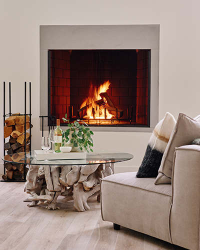 A cozy living room with a fire roaring in the fireplace at Sol Haus in Union Pier, Michigan