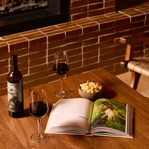 Two glasses of wine, popcorn, and a book fireside at The Living Room at Marina Grand Resort in New Buffalo, Michigan