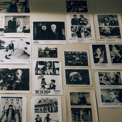 Old film posters tacked to the wall inside the projector room at Vickers Theatre in Three Oaks Michigan