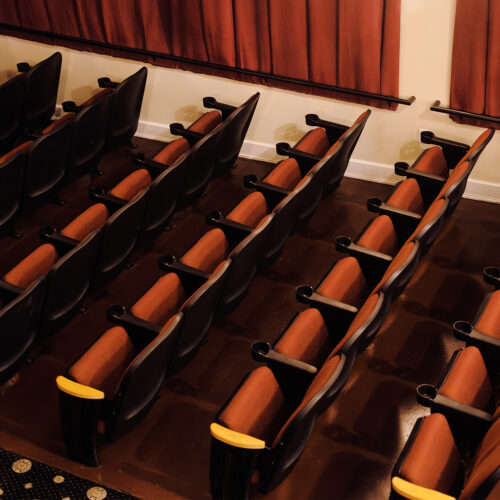A row of red theater seats at Vickers Theatre in Three Oaks Michigan