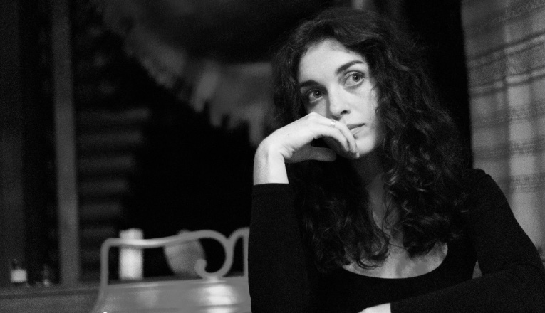 Singer Livia Gazzolo alone, looking thoughtful.