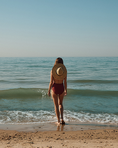 A lady walks toward the water by the beach near New Buffalo, Michigan