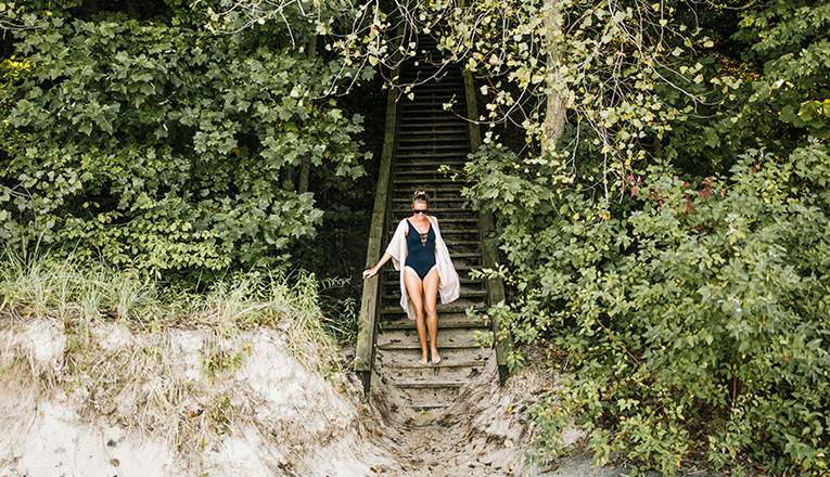 A woman descends the stairs at Cherry Beach in Harbert, Michigan