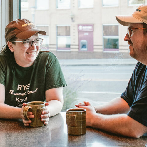 Owners Joe and Emma drink coffee inside David's Deli in New Buffalo, Michigan