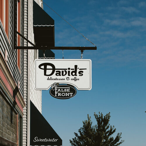 A sign hangs off the exterior of David's Delicatessen and Coffee in New Buffalo, Michigan