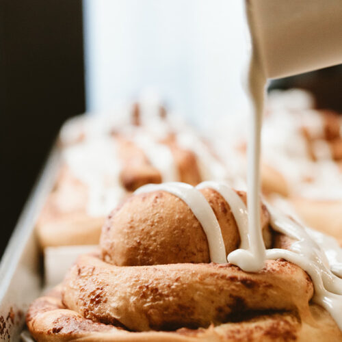 Icing pours over cinnamon buns at David's Deli in New Buffalo, Michigan