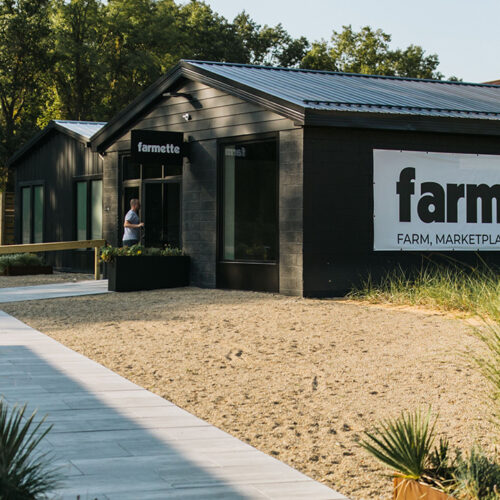 The exterior of Farmette in New Buffalo, Michigan. The sign reads Farmette. Farm, Marketplace, Bakery, and Cafe.