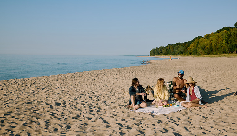 Friends have a beach picnic near Lakeside, Michigan