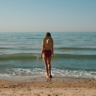 A lady walks toward the water by the beach near New Buffalo, Michigan