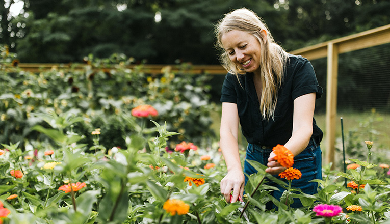 Katie Burdett trims flowers on the farm at Farmette in New Buffalo, Michigan