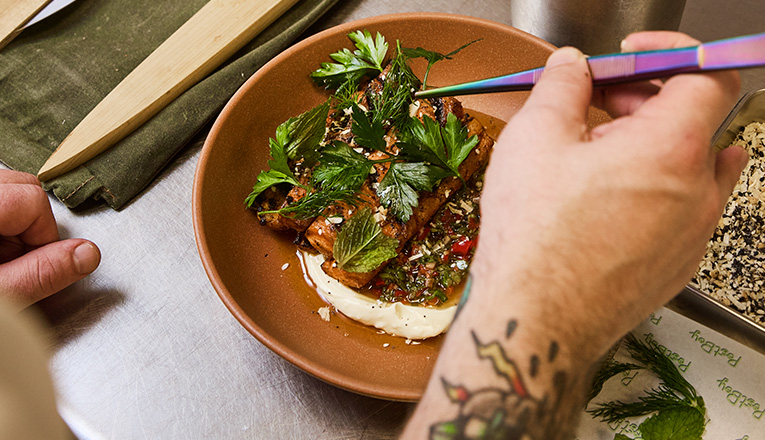 Chef James Galbraith preparing a dish in the kitchen at PostBoy in New Buffalo, Michigan