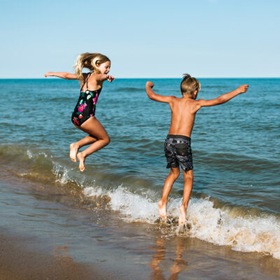 Kids joyously jumping in Lake Michigan