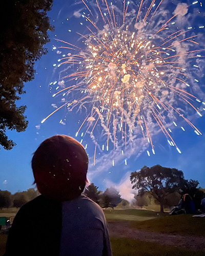 A child looks up at fireworks in the sky near New Buffalo, Michigan