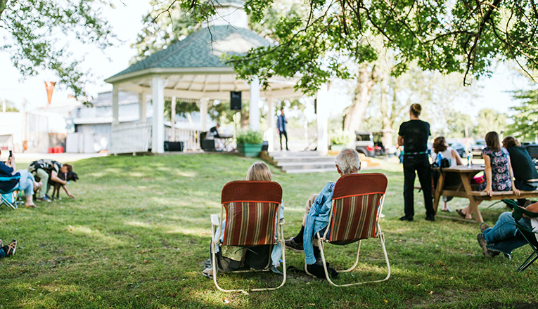 A couple in lawn chairs for music in the park near Three Oaks, Michigan