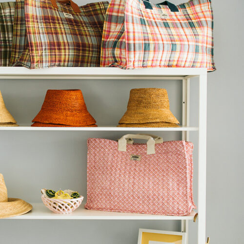 Beach bags and hats on racks at BEACH in New Buffalo, Michigan