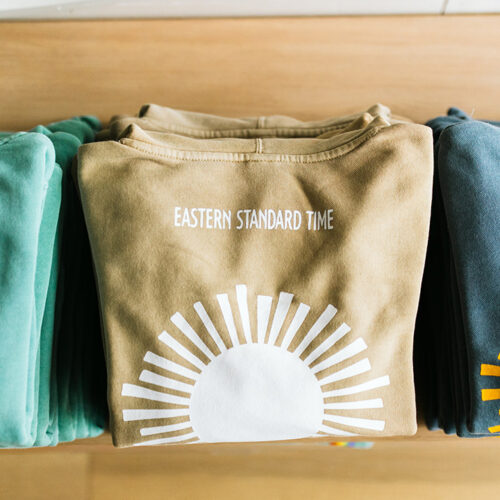Graphic sweatshirts folded at Eastern Standard Time in New Buffalo, Michigan