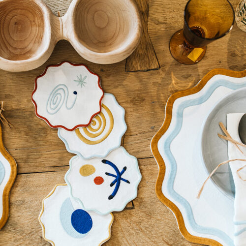 Graphic cloth coasters next to a placesetting at Lakeside Goods in New Buffalo, Michigan