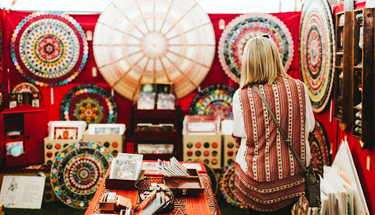 A woman looks at mandala art at Outsiders Outside Art Fair at Judith Racht Gallery in Harbert, Michigan
