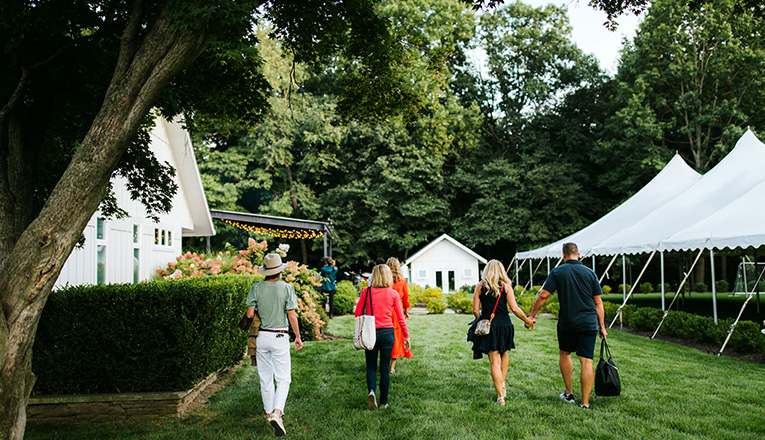 A group of concert goers walk to the back of Apple Blossom