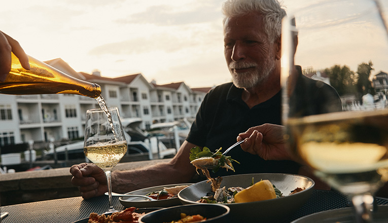 White wine is poured to a guest dining outdoor at Bentwood Tavern in New Buffalo, Michigan