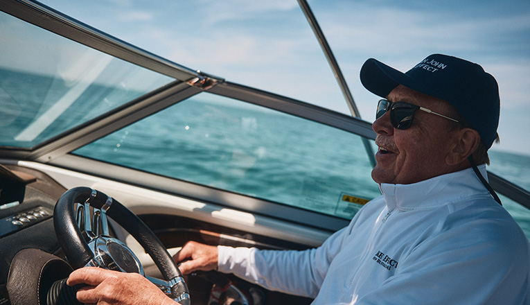 Captain John Hartmann drives his motorboat in Lake Michigan