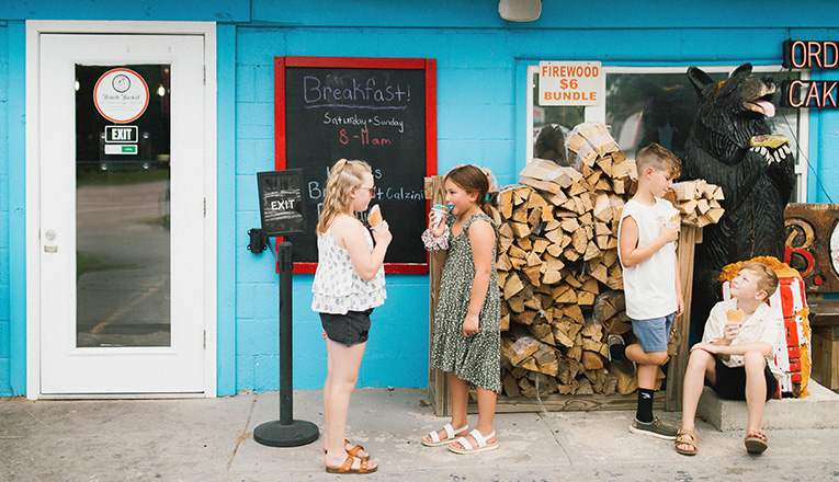 Kids eat ice cream outside The Beach Bucket in Sawyer, Michigan