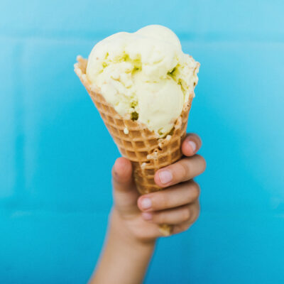 A hand holds up a waffle cone at The Beach Bucket in Sawyer, Michigan