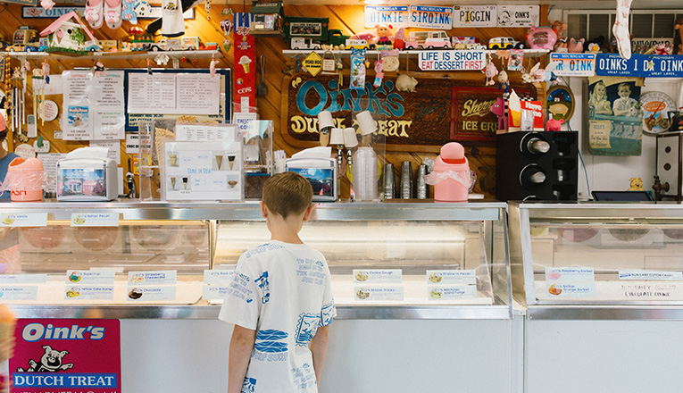 A boy looks down at the ice cream flavors at Oinks Dutch Treat in New Buffalo, Michigan