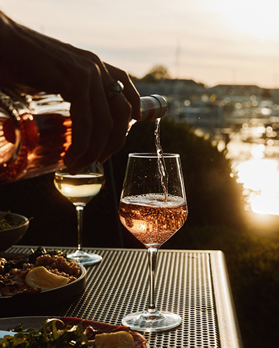 Rosé is poured as the sun sets at Terrace Room in New Buffalo, Michigan