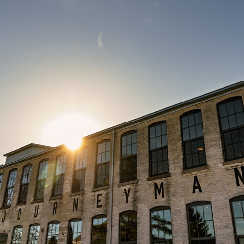 The sunset setting over the historical Journeyman Distillery building in Three Oaks, Michigan