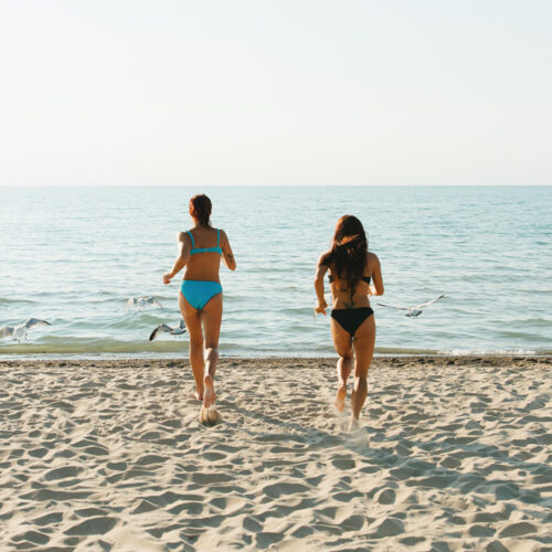 Two ladies run into Lake Michigan