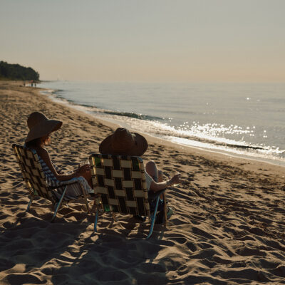 Beachgoers enjoy a glass of wine on near the Lake Michigan shore